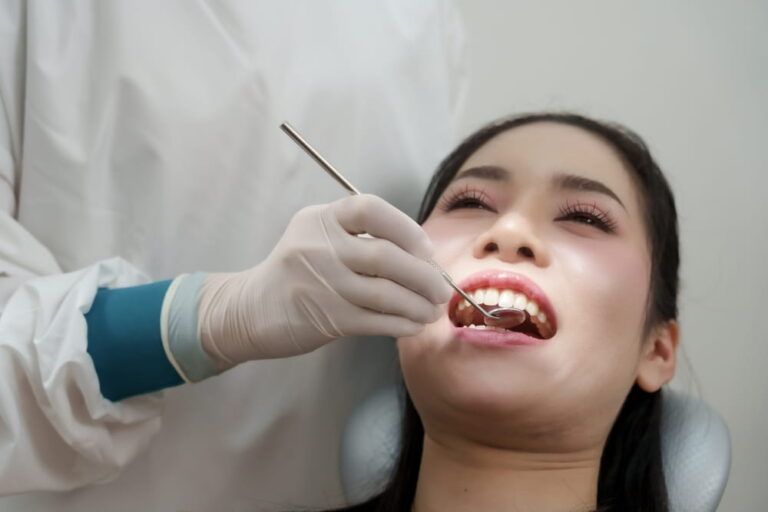 Dental mirror and scaler used to inspect teeth for plaque and tartar buildup before cleaning procedure